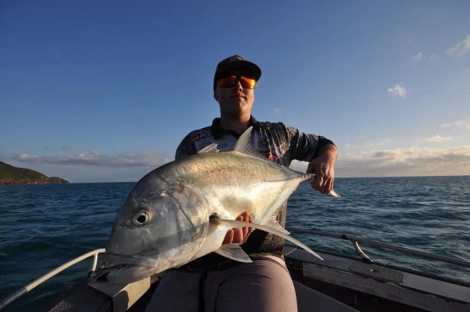 A giant trevally boated as the sun goes down